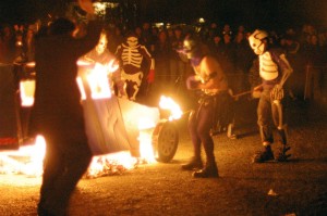 People in costume burning a cardboard SUV