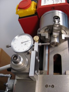 View of Mini Lathe carriage, cross slide, quick change toolpost with indicator holder mounted and four jaw chuck from above